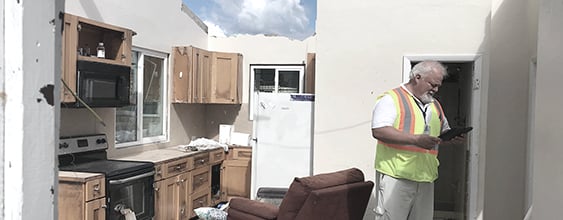 WSP employee performing FEMA inspection on a home following a natural disaster