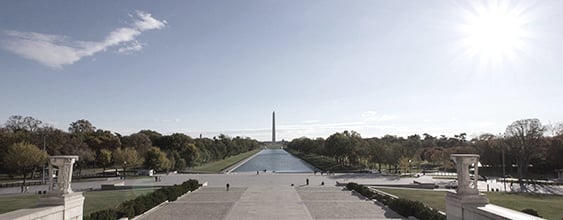 Distant view of the Washington Monument across the reflecting pool on a sunny day