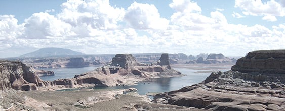 Expansive blue sky view of Grand Canyon National Recreation Area showing rock formations and river