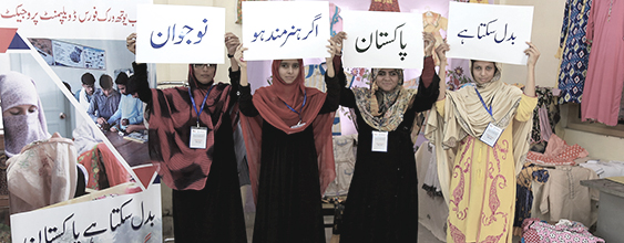 Pakistani women hold signs supporting workforce education. WSP partnered with USAID to develop a workforce development program.